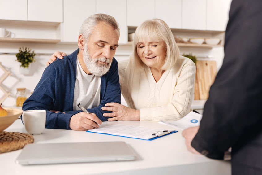 73797765 – delightful elderly couple signing documents at home